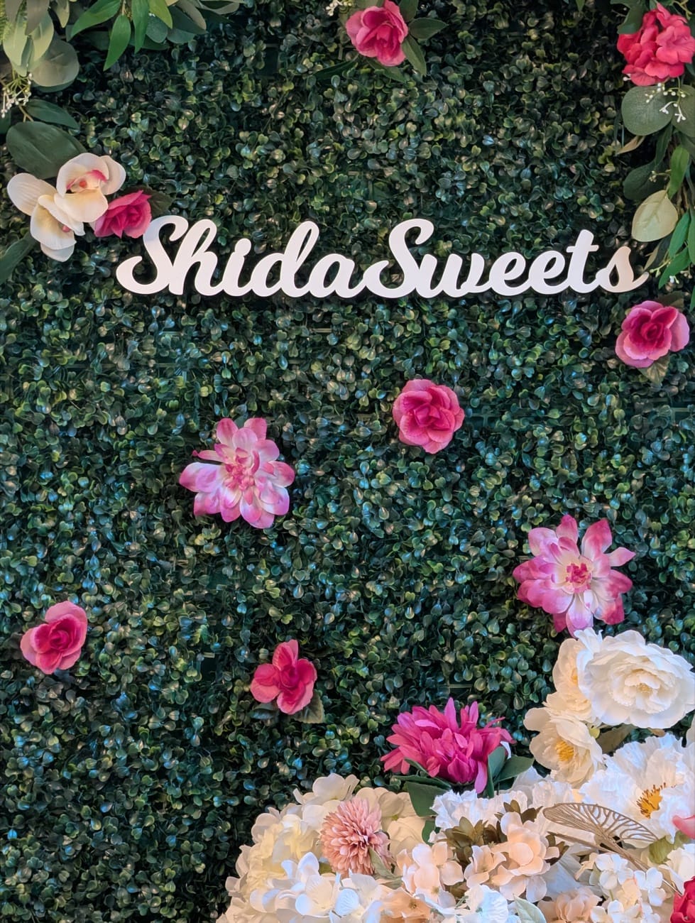 ShidaSweets floral branding wall